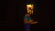 Steve holding blaze rods while standing next to a blaze (Image via Mojang)